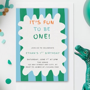 May include: A birthday invitation with the text "IT'S FUN TO BE ONE!" in orange and green. The invitation is decorated with green and blue stripes and a white border. Green balloons and a dinosaur figurine are also present.
