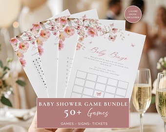 May include: A set of white paper baby shower game cards featuring pink floral and butterfly illustrations. The cards include text for Baby Bingo and other activities. A circular badge in the corner states 7 GAME SIGNS INCLUDED.