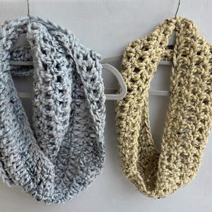 May include: A set of three ceramic mugs with a speckled, matte finish. The mugs are in shades of cream, light gray, and dark gray. Each mug has a simple, minimalist design, perfect for coffee or tea.