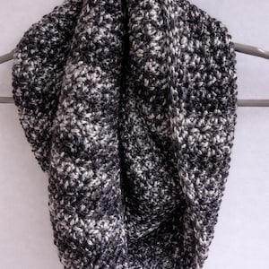 May include: A white ceramic mug with a black handle and the text "But First, Coffee" in a black, handwritten-style font. The mug is on a white surface.