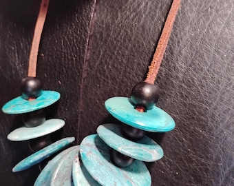turquoise accent discs on a leather cord