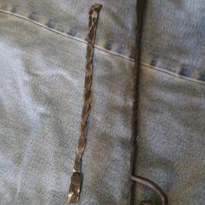May include: Two metal tools with twisted handles. The tool on the left is straight and the tool on the right has a loop at the end.