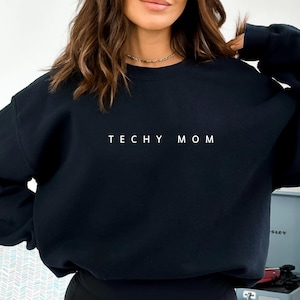 May include: Black sweatshirt with the text "Techy Mom" in white lettering.