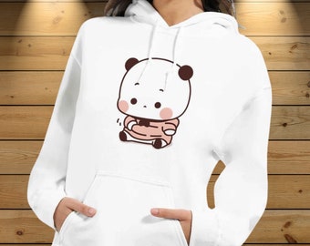 May include: White hooded sweatshirt with a cute cartoon panda wearing a pink shirt. The panda is sitting down with its arms crossed and has a small smile on its face.