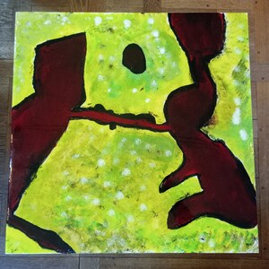 May include: Abstract painting with two large, dark red shapes on a bright yellow background with white speckles. The shapes are outlined in black and appear to be interacting with each other.