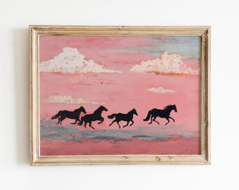 May include: Framed artwork featuring four black horse silhouettes galloping across a pink and blue sky with white clouds. The painting has a gold-colored frame, adding a touch of elegance to the piece.