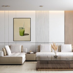May include: A white sectional sofa with beige cushions sits in a modern living room with a wood slat wall and a framed print of a green drink with a straw.