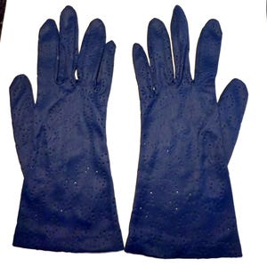 May include: A pair of blue gloves with a dotted pattern. The gloves are made of a soft, stretchy material.