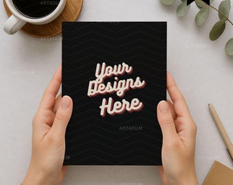 May include: A black card with a chevron pattern is held in hands. The card features the text "Your Designs Here" in a retro font. A cup of coffee, a wooden coaster, and a pen are in the background.
