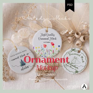 May include: Three white circular ceramic ornaments with gold hanging strings. The left ornament features a pine tree graphic and text. The center ornament displays a colorful wildflower print and text. The right ornament shows a line art rabbit graphic.