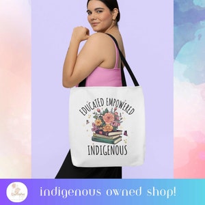 May include: White tote bag with black handles featuring a floral design with a stack of books and the text "Educated Empowered Indigenous".