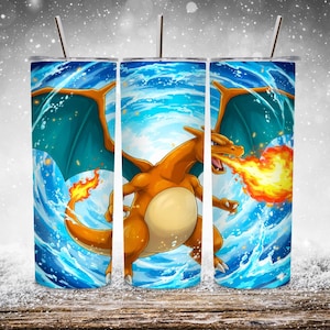 May include: A stainless steel tumbler with a Charizard illustration. The design features a fiery orange dragon-like creature against a swirling blue and white background. The design includes a flame effect and teal wings.