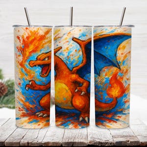 May include: Three stainless steel tumblers with a vibrant, artistic design featuring a Charizard character. The artwork showcases the creature in shades of orange, yellow, and blue, with a fiery and dynamic aesthetic. Each tumbler includes a silver straw.