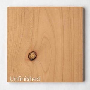 May include: A square, unfinished wooden board with a light brown color and visible wood grain. A knot is present near the center. The word "Unfinished" is printed in white at the bottom left corner of the board.