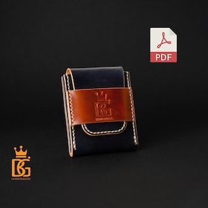 May include: A handcrafted leather wallet in navy blue and brown, featuring a stitched design and a decorative emblem. The wallet has a secure closure and is designed for carrying cards and cash.