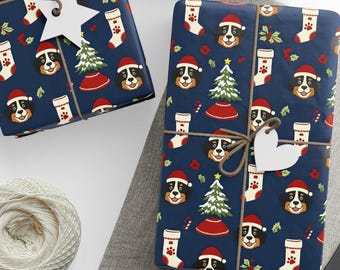 May include: Wrapped gifts with navy blue paper featuring a repeating pattern of dogs in Santa hats, Christmas trees, and stockings. Each package is tied with twine and a white tag. A ball of twine and scissors are also visible.