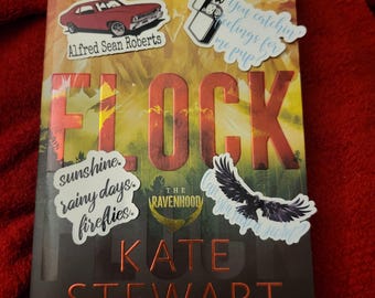 May include: A book titled "Flock" by Kate Stewart, an internationally bestselling author. The book cover features a red car, a bird, and a lighter with the text "Can you keep a secret?" and "You catchin feelings for me pup?"
