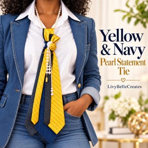 May include: A yellow and navy blue patterned necktie accessory featuring a pearl necklace, a fabric flower, and dangling pearl strands. The tie is worn over a white collared shirt and a denim blazer. Text reads Yellow & Navy Pearl Statement Tie.