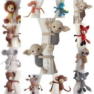 May include: A set of 12 crocheted animal curtain tiebacks. The tiebacks are made in a variety of colours and feature different animals, including a lion, a monkey, a dragon, a fox, a sloth, a unicorn, a giraffe, a monkey, a cat, a dog, a rabbit, and a bear.