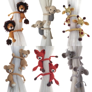 May include: A collection of crocheted curtain tiebacks in the shape of various animals, including lions, sheep, giraffes, bears, foxes, and elephants. The tiebacks are in various colors, including brown, red, gray, and yellow. They are designed to wrap around curtains.
