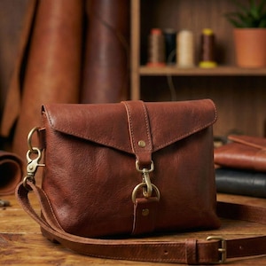 Brown bison leather crossbody sling bag with flap, adjustable strap and brass ring buckle—handmade leather bag.