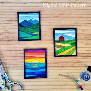 May include: Three rectangular fabric quilt blocks featuring landscape scenes: one with blue mountains, one with a red barn in a field, and one with a sunset over water. The text Digital FPP Pattern is visible at the top. Scissors and pins are nearby.