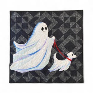 May include: A square quilt featuring a white ghost figure walking a small white dog on a red leash. The background is a dark charcoal fabric with a white geometric star-like pattern. The ghost and dog are appliqued onto the dark fabric surface.