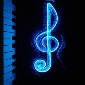 May include: A glowing blue treble clef design against a black background. The musical symbol is illuminated with a neon-like effect, with a piano keyboard visible on the left side. The image evokes a sense of music and artistry.