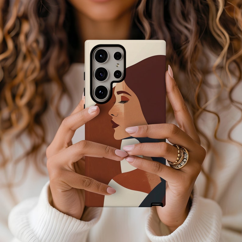 May include: A phone case with a beige background and a colorful abstract design featuring a woman's face. The case has a black camera cutout and a black border.