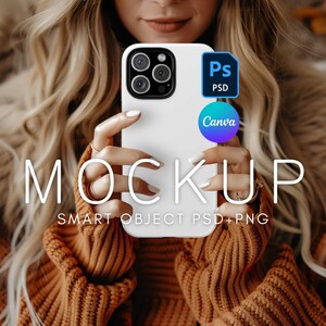 May include: A white phone case mockup with a camera lens cutout and the text "MOCKUP SMART OBJECT PSD+PNG" on the bottom. The phone case is being held by a person wearing a brown sweater.