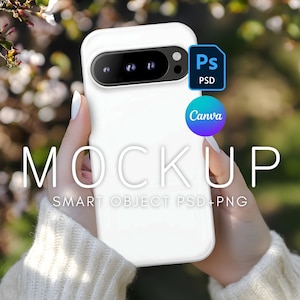May include: White smartphone mockup with a black camera lens and a white background. The phone is being held by a hand with a white sweater. The text "MOCKUP" and "SMART OBJECT PSD+PNG" is visible on the image.