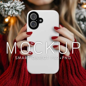 May include: White phone case mockup with a dual camera lens. The case is being held by a person wearing a red sweater. The text "MOCKUP SMART OBJECT PSD+PNG" is visible on the case.