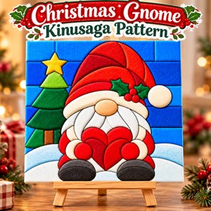 May include: A Kinusaga pattern craft featuring a gnome wearing a red hat with holly, holding a red heart, next to a green Christmas tree with a yellow star, set against a blue brick background, with the text Christmas Gnome Kinusaga Pattern.