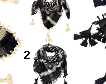 May include: Two black and white patterned keffiyeh scarves with fringe tassels. One scarf has cream tassels and the other has black tassels.