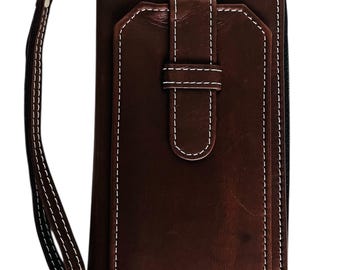 May include: A brown leather wallet with white stitching and a wrist strap. The wallet has a rectangular shape with a flap and a buckle closure. The stitching is visible around the edges and on the flap.