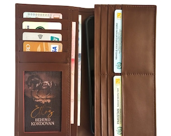 May include: Open brown leather wallet with multiple card slots, a clear ID window, and a pocket for cash. The wallet is filled with cards, bills, and a smartphone. The text "BEHIND KORDOVAN" is visible.