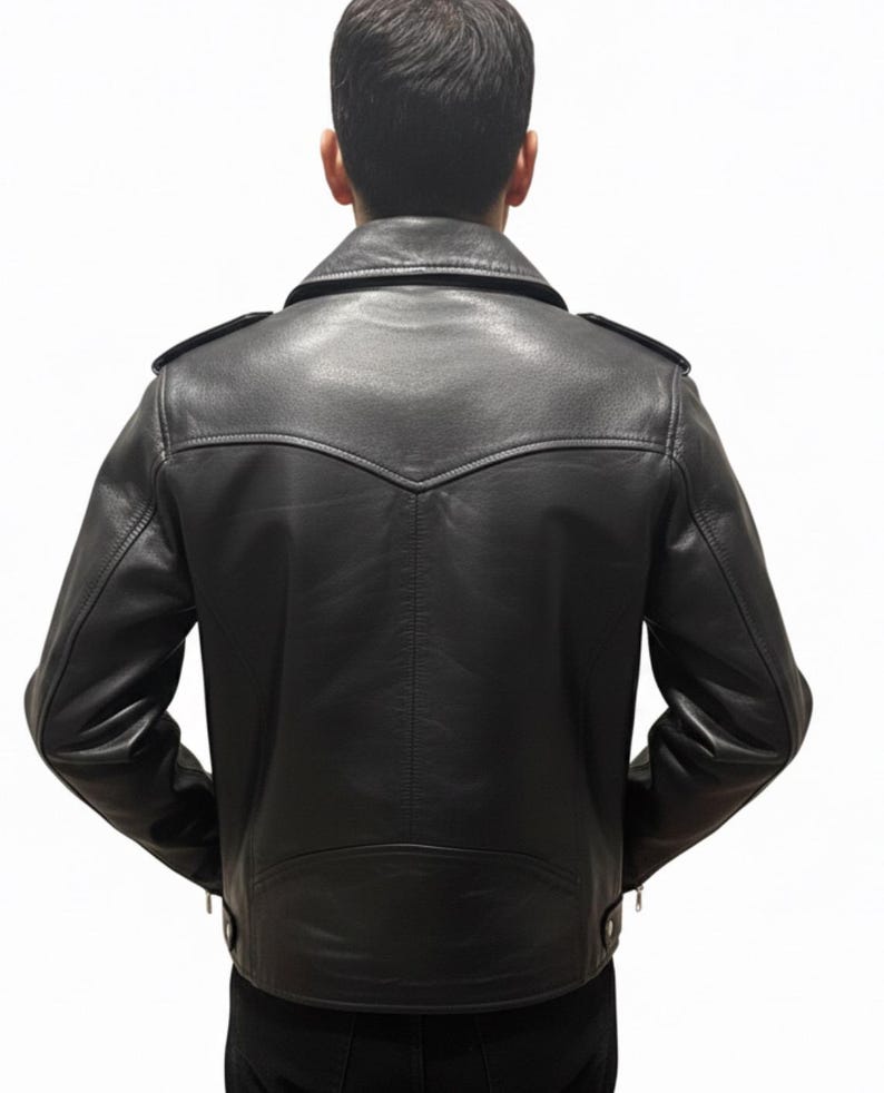 May include: Black leather jacket with a classic design, featuring a notched collar, shoulder epaulets, and a tailored fit. The jacket has a zipper closure and a decorative back panel. A timeless piece of outerwear.