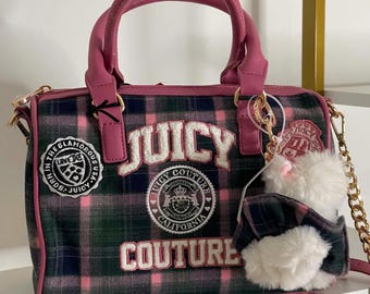 May include: A handbag featuring a green, navy, and pink plaid pattern with pink trim and handles. The bag displays the text "JUICY COUTURE" in white lettering, along with circular patches and a white plush bear charm attached to a gold chain strap.