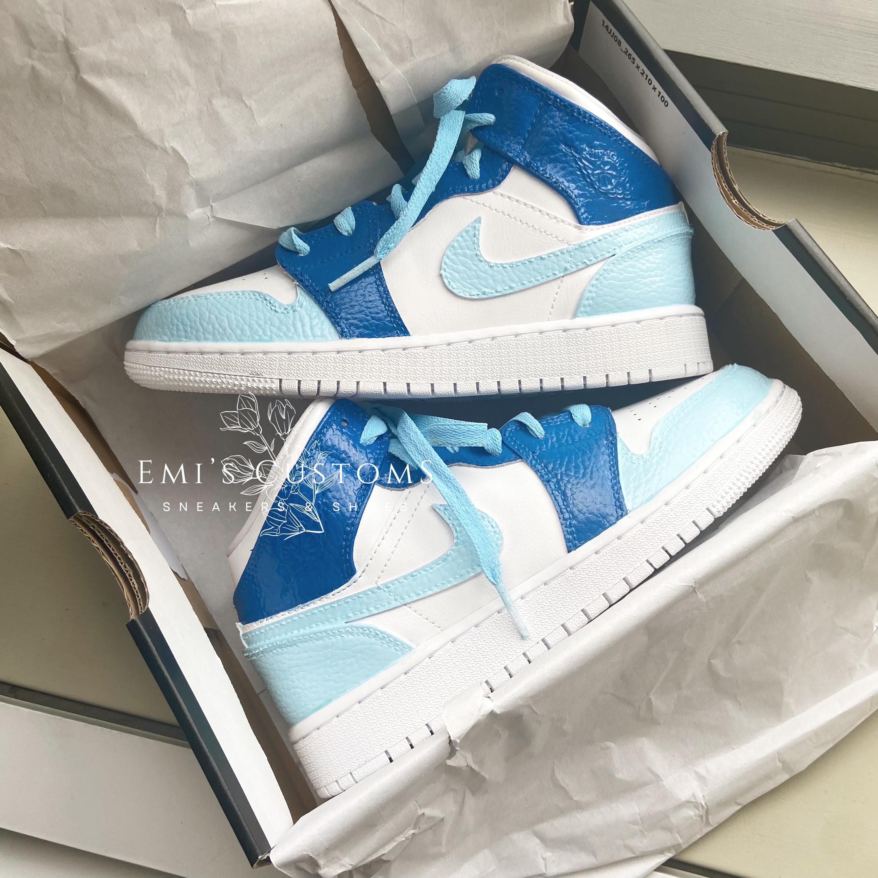 white and light blue jordans