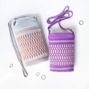 May include: Two crocheted bags with adjustable straps. The bag on the left is light blue with a brown geometric pattern. The bag on the right is purple with a white geometric pattern.