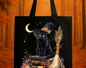 May include: Black tote bag featuring a black cat wearing a witch hat, sitting on a stack of books. A crescent moon and stars are in the background. A broom and pumpkins are also featured in the design. The bag has black handles.