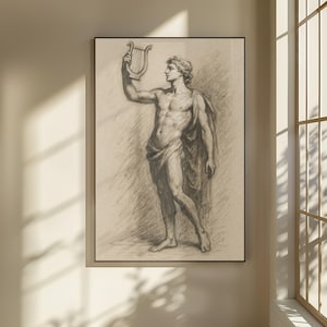 May include: A framed pencil sketch of a classical male figure holding a lyre. The figure is draped in cloth and wears a laurel wreath. The artwork is in a black frame and has a neutral background.