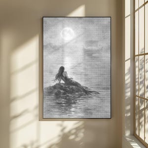 Könnte beinhalten: Schwarz-Weiß-Kunstdruck einer Meerjungfrau auf einem Felsen, die den Vollmond betrachtet. Ein Schiff segelt in der Ferne. Das Kunstwerk ist gerahmt und an einer Wand befestigt.