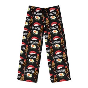 May include: Black pyjama trousers with a repeating pattern of sushi, prawn tempura, and chopsticks. The text "Jaxon" is repeated throughout the pattern.
