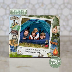 May include: A framed photo featuring a family inside a blue tent, with camping-themed illustrations. The text "Camping Adventure Yellowstone 2026" is visible. Additional illustrations include a compass, campfire, and hiking boots.