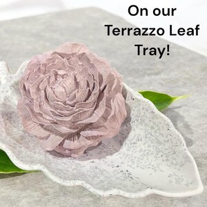 A peony concrete aroma stone on a leaf shaped dish