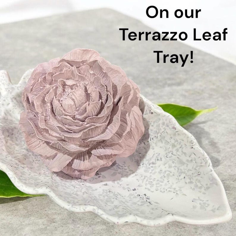A peony concrete aroma stone on a leaf shaped dish