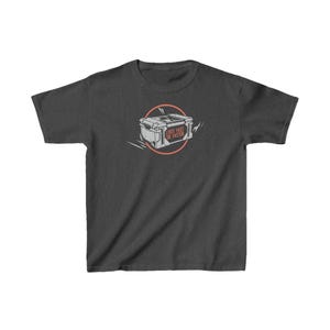 May include: Dark gray t-shirt featuring a graphic of a treasure chest inside a pink circle. The chest has the text "LOOT FAST OR FASTER" in orange. The shirt is a short-sleeved, crew neck style.