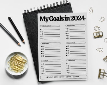 May include: A white printable goal planner with the title "My Goals in 2024". The planner is divided into six sections: Professional Goals, Personal Goals, Health Goals, Financial Goals, Love Goals, and Passion Goals. Each section has a checklist with blank lines for writing goals. The planner is on a white surface with gold paper clips and pencils.