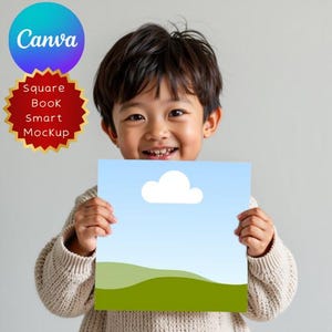 May include: A smiling child holds a square mockup featuring a blue sky with a white cloud and green hills. The Canva logo is in the upper left corner, and the words "Square Book Smart Mockup" are in a red starburst.